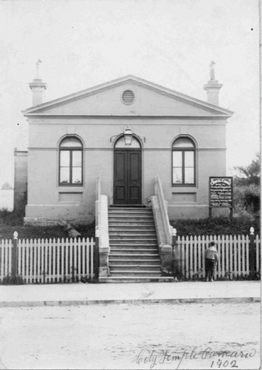 A small building with stairs leading to the front

AI-generated content may be incorrect.