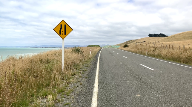 A road with a sign on the side

AI-generated content may be incorrect.