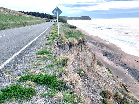 A road with a sign on the side of the road

AI-generated content may be incorrect.